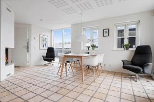 a kitchen and dining room with a table and chairs at LK1524-Lokken-Josefines-Have-51 in Løkken
