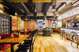 a restaurant with tables and chairs and a brick wall at Townhouse Oak Kodambakkam Formerly Cine City in Chennai