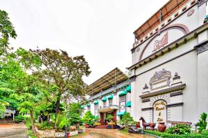 a large white building with trees in front of it at S79 Phu Van Aires Beach Bungalow in Phu Quoc