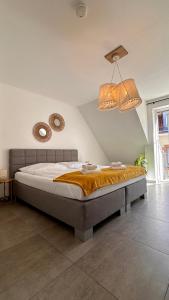 a bedroom with a bed and two mirrors on the wall at AMAO-Curry - City Center - 100 m2 - 7 Personen - Balkon - 2 Schlafzimmer - KingSize Betten in Lahr +29 photos
