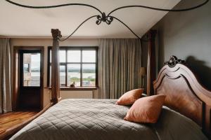 a bedroom with a large bed and a window at Hotel Kriunes in Reykjavík +126 photos