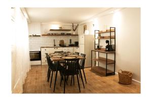a dining room with a table and chairs in a kitchen at Waves Of Eros in Paralía