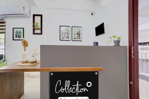a white counter with a chalkboard sign on it at Super Collection O Valiyavila Junction Formerly Prism Heights in Trivandrum