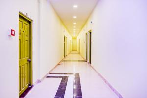 an empty corridor of an office building with yellow doors at Super Collection O Howrah Botanical Garden Formerly Tanima Villa in Sāntrāgāchi