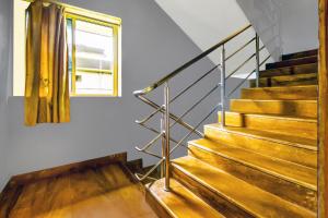 a staircase in a building with a window at Hotel O Porvorim Near Mall De Goa in Goa