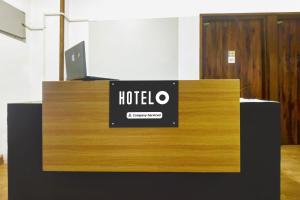a sign for a hotel on top of a desk at Hotel O Porvorim Near Mall De Goa in Goa