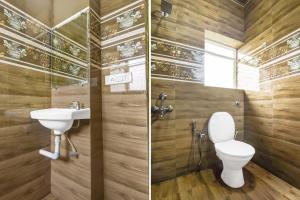 a bathroom with a toilet and a sink at Hotel O Porvorim Near Mall De Goa in Goa