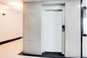 an open door in a room with white walls at Townhouse Margao Near Railway Station Formerly Hotel Tanish in Goa +48 photos