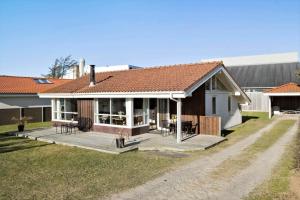 a house with a large deck in the yard at BL222-Blokhus-Jens-Baerentsvej-16 in Blokhus