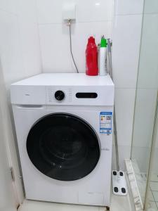 a white washing machine sitting in a room at Fanhua Life IN Nanjing West Road Store 2 in Shanghai