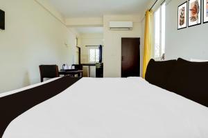 Postel nebo postele na pokoji v ubytování Super Hotel O Anjuna