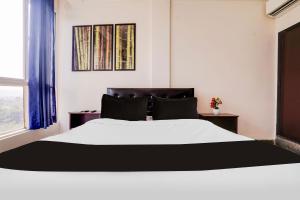 Postel nebo postele na pokoji v ubytování Super Hotel O Anjuna
