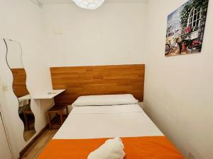 a small bedroom with a bed and a desk at Rooms in Madrid Downtown in Madrid +34 photos