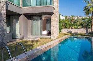 a house with a swimming pool next to a building at ares yalıkavak in Bodrum City