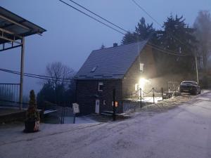 a house with a car parked in front of it at Mátrai5Vendégház Galyatető in Mátraszentimre