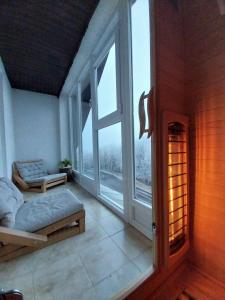 a room with a bed and a large window at Mátrai5Vendégház Galyatető in Mátraszentimre