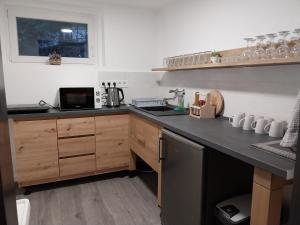 a kitchen with a sink and a counter top at Mátrai5Vendégház Galyatető in Mátraszentimre