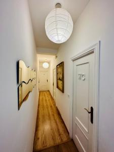 a hallway with white walls and a white door at Rooms in Madrid Downtown in Madrid