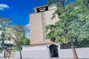 a building with a sign on top of it at Super Hotel O Bopodi Near Pune IT Park in Pune