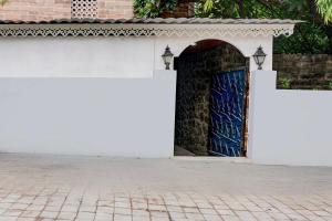 a white wall with a blue door on a building at Super Hotel O Bopodi Near Pune IT Park in Pune