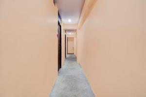 a hallway of a house with a concrete floor at OYO Townhouse Civil Lines Prayagraj Formerly Raj Mahal Palace in Civil Lines