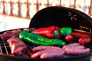 a bunch of peppers and other vegetables cooking on a grill at Edomus Castillo de las Guardas in Seville