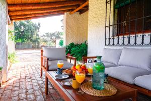 a table with glasses of orange juice on a patio at Edomus Castillo de las Guardas in Seville