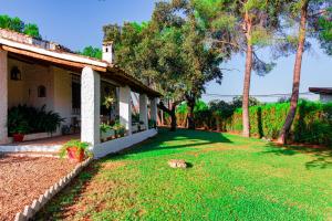 a yard of a house with a dog laying in the grass at Edomus Castillo de las Guardas in Seville