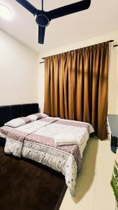 a bed in a room with a curtain at Teratak Raya in Tanjung Rambutan