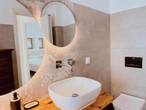 a bathroom with a white sink and a mirror at Spiti su in Paros - Naousa con vista in Kampos Paros +9 photos