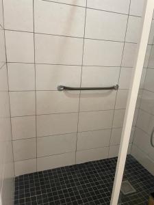 a bathroom with a white tiled wall with a towel rack at Résidence Le Carillon in Saint-André +18 photos