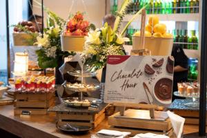 a display of food and desserts on a table at Mövenpick Hotel Sukhumvit 15 Bangkok in Bangkok +168 photos