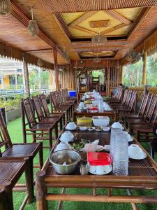 a long table with plates of food on it at Đầm sen Resort in Hòa Lạc
