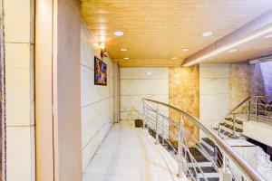 a staircase in a building with a stained glass window at Hotel O Ambedkar Chowk Ulhasnagar in Kalyan +46 photos