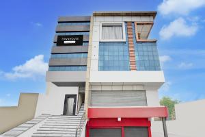 a building with a red door in front of it at Townhouse Narholi Bridge Mathura in Mathura
