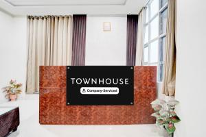 a view of a room with a sign that reads townhouse and company services at Townhouse Narholi Bridge Mathura in Mathura