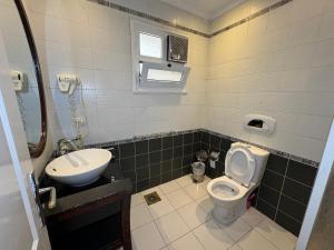 a bathroom with a toilet and a sink at Herrmes in Sharm El Sheikh
