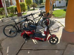 a scooter and a bicycle parked next to a building at Herrmes in Sharm El Sheikh