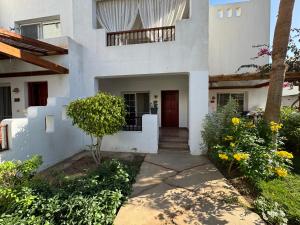 a white house with a red door at Herrmes in Sharm El Sheikh