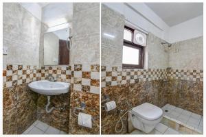 a bathroom with a toilet and a sink at Hotel O Alipore Near Chetla Formerly Alipore Guest House in Kolkata