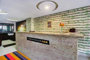 a lobby with a sign that reads tumkus oak at Super Townhouse Oak LB Nagar Ramoji in Hyderabad