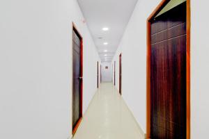 a hallway with doors and a long corridor at Super Hotel O Moula Ali Neredmet in Hyderabad