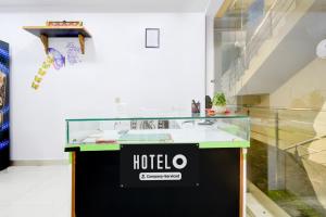 a glass counter with a hotel sign on it in a room at Super Hotel O Moula Ali Neredmet in Hyderabad