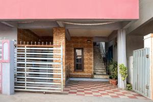 a entrance to a house with a gate and stairs at Super Hotel O Dhanori Near Pune Airport in Pune