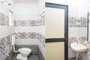 a bathroom with a toilet and a sink at Super Hotel O Dhanori Near Pune Airport in Pune