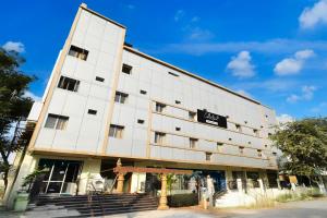 a large white building with a sign on it at Super Collection O Godavari Kompally in Hyderabad
