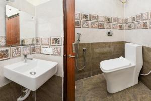 a bathroom with a sink and a toilet and a shower at Super Collection O Godavari Kompally in Hyderabad