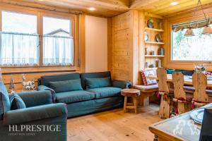 a living room with a couch and a table at Dimora del Corso Cortina in Cortina dʼAmpezzo