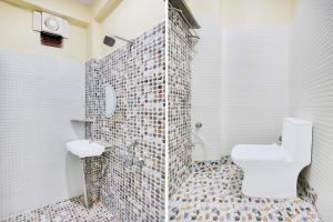 a white bathroom with a toilet and a mirror at Super Collection O Nagwa Lanka Varanasi in Varanasi