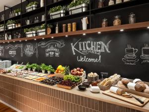 a bakery with a blackboard with food on it at Hotel Sadova in Gdańsk